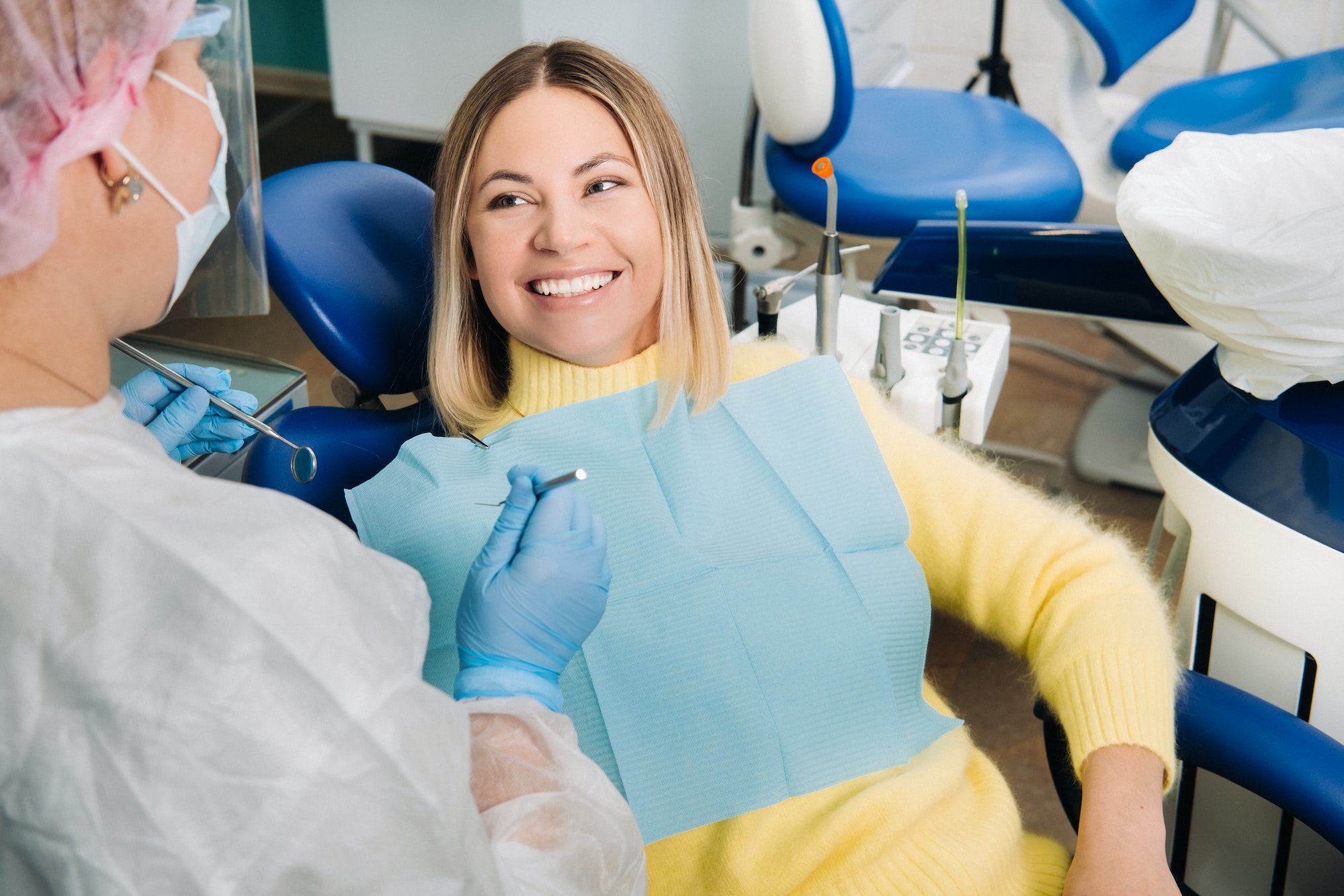 The girl smiles at the dentist and looks at her The girl smiles at the dentist and looks at her